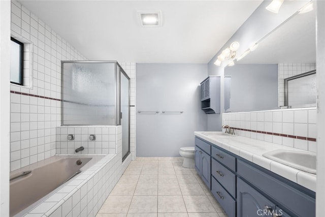 full bathroom featuring toilet, vanity, tile patterned floors, and plus walk in shower