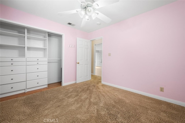 unfurnished bedroom with ceiling fan, a closet, and carpet floors