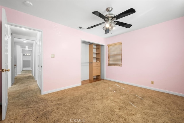 unfurnished bedroom featuring carpet flooring, ceiling fan, and a closet