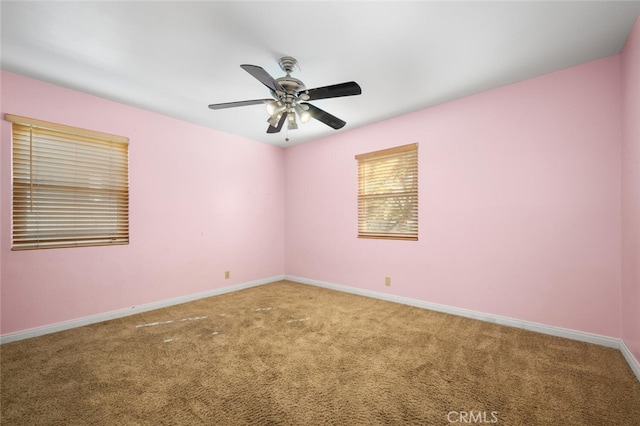 carpeted spare room featuring ceiling fan