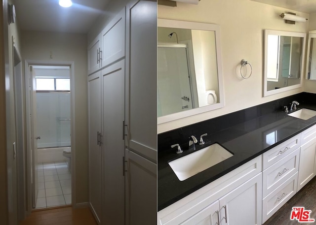 bathroom with tasteful backsplash, vanity, wood-type flooring, and toilet