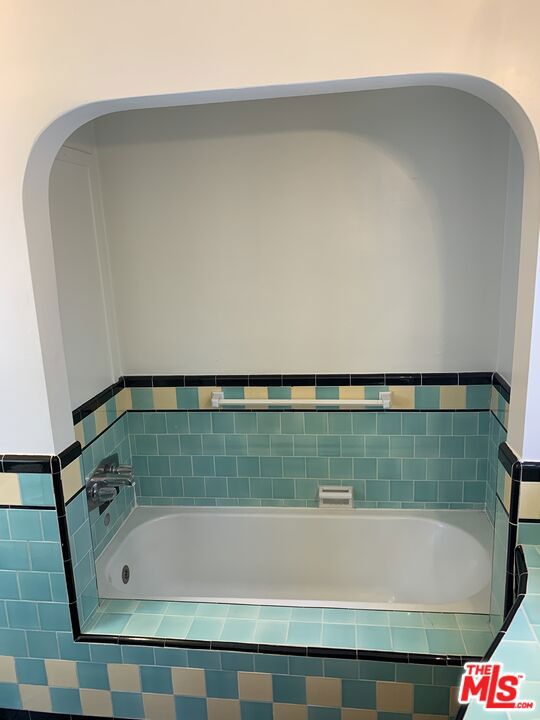 bathroom featuring tiled tub