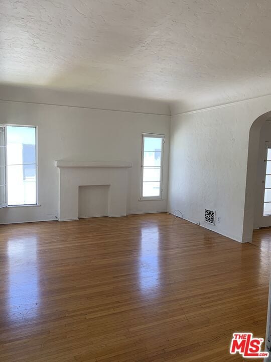 unfurnished living room featuring dark wood-type flooring