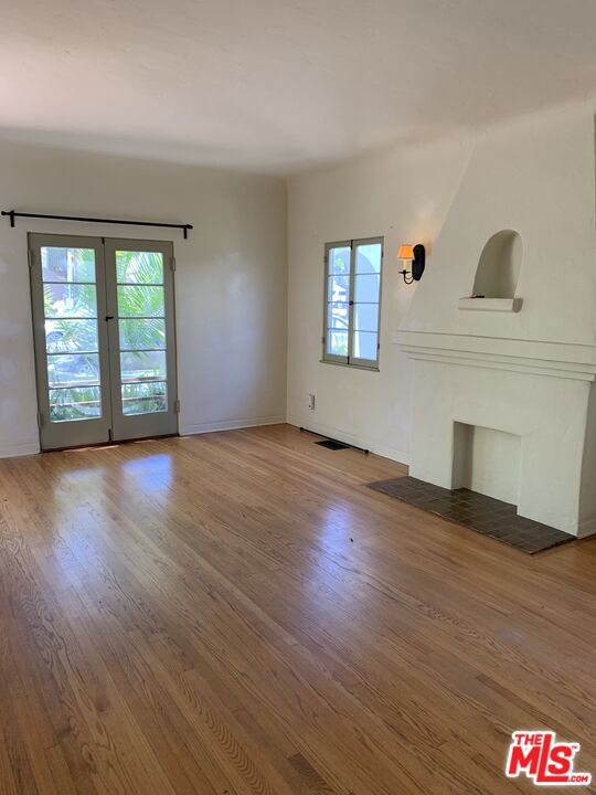 unfurnished living room with wood-type flooring