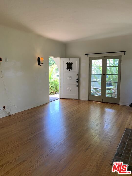 foyer entrance with wood-type flooring and a healthy amount of sunlight