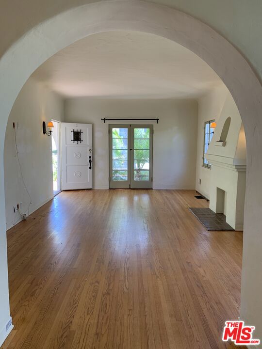 interior space featuring french doors and hardwood / wood-style flooring