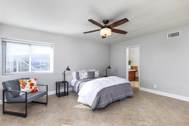 bedroom with light tile patterned floors, ceiling fan, and ensuite bathroom