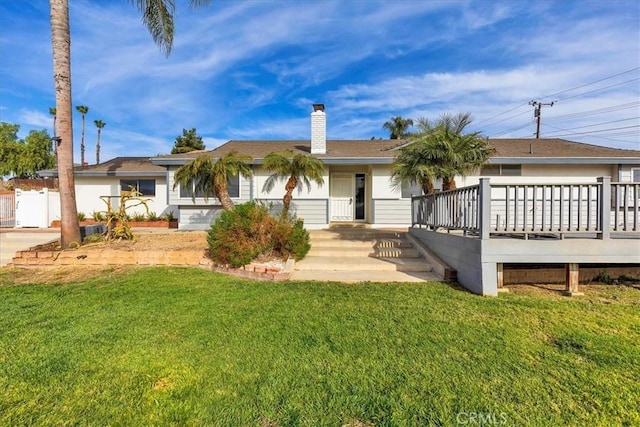 ranch-style house with a wooden deck and a front yard