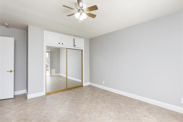 unfurnished bedroom with light tile patterned floors, a closet, and ceiling fan