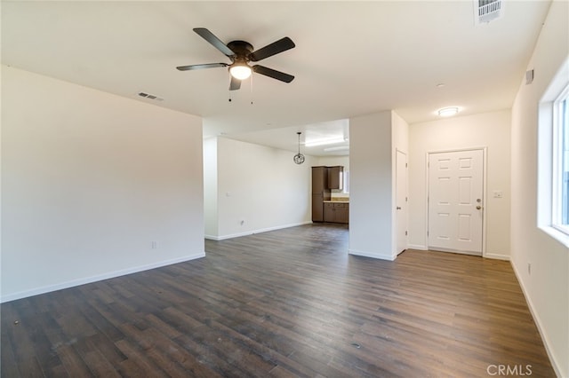 unfurnished living room featuring dark hardwood / wood-style floors and ceiling fan