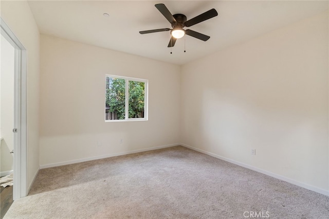 unfurnished room featuring light carpet and ceiling fan