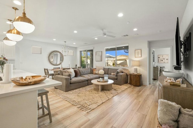 living room featuring light wood-type flooring and ceiling fan