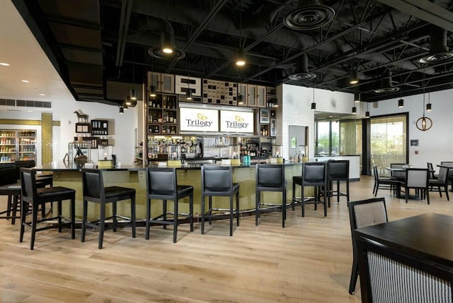 bar with light hardwood / wood-style flooring