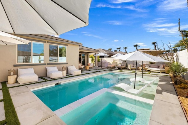 view of swimming pool featuring a patio area and an in ground hot tub