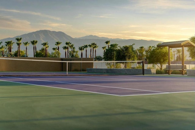 view of sport court featuring a mountain view and basketball hoop