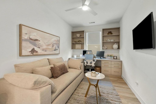 living room with ceiling fan and light wood-type flooring