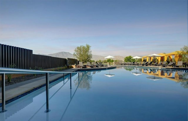 view of swimming pool with a mountain view