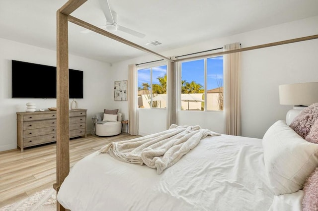 bedroom with ceiling fan and light hardwood / wood-style floors