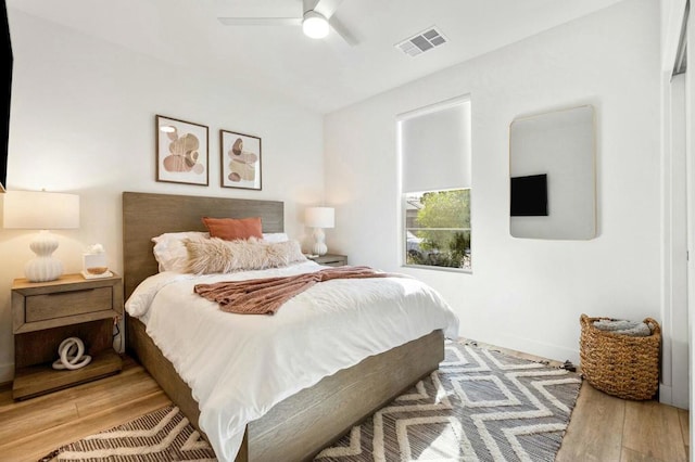 bedroom with ceiling fan and light wood-type flooring