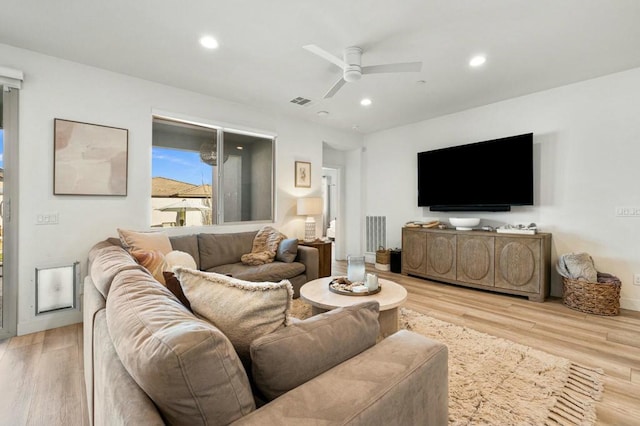 living room featuring ceiling fan and light hardwood / wood-style flooring