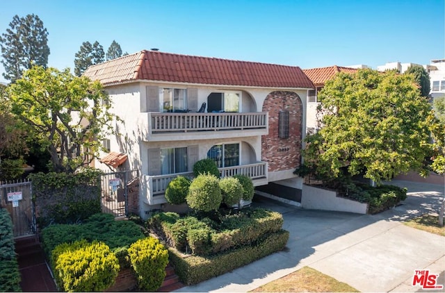 mediterranean / spanish home featuring a balcony