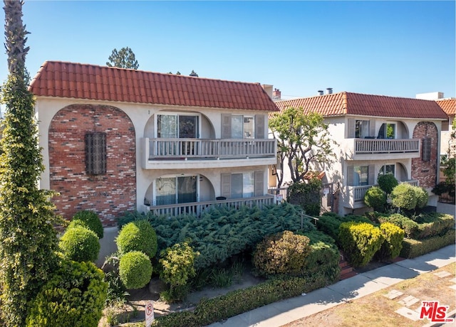 mediterranean / spanish home featuring a balcony