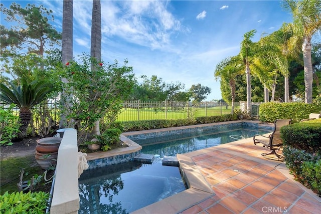 view of swimming pool with an in ground hot tub