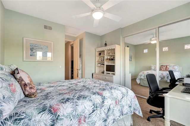 carpeted bedroom with ceiling fan and a closet