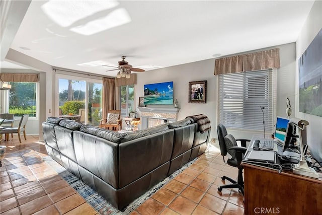 tiled living room featuring ceiling fan