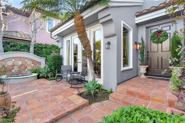 property entrance featuring a patio