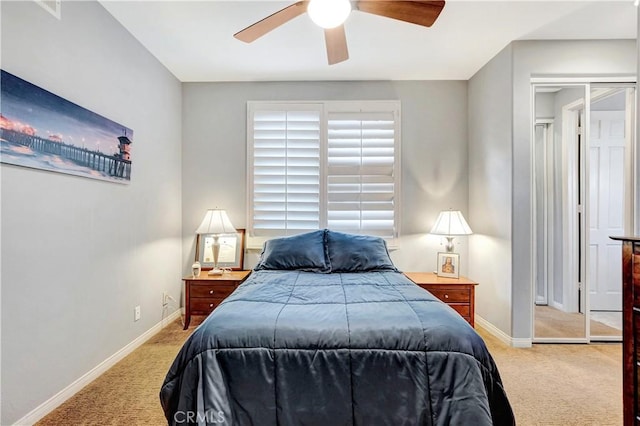 bedroom featuring ceiling fan, light colored carpet, and a closet