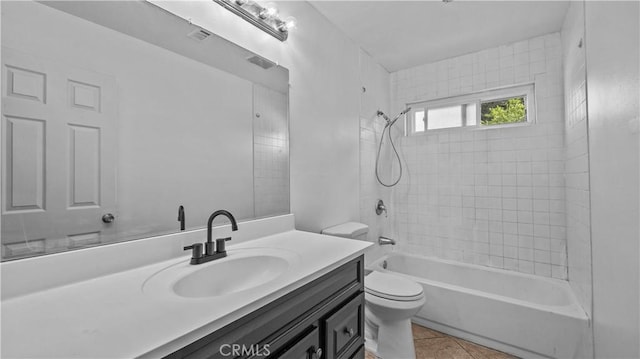 full bathroom with tile patterned floors, vanity, toilet, and tiled shower / bath