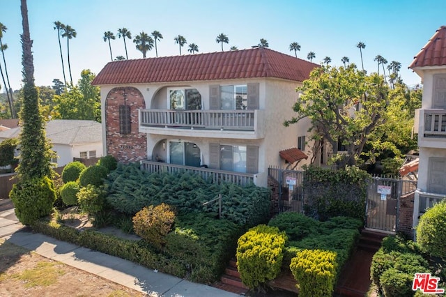 mediterranean / spanish home with a balcony