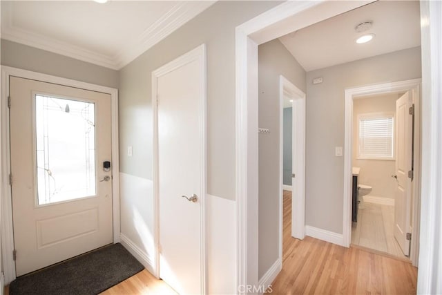 doorway featuring light wood-type flooring and ornamental molding