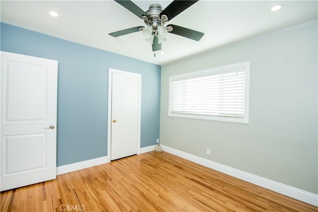 unfurnished bedroom featuring hardwood / wood-style floors and ceiling fan