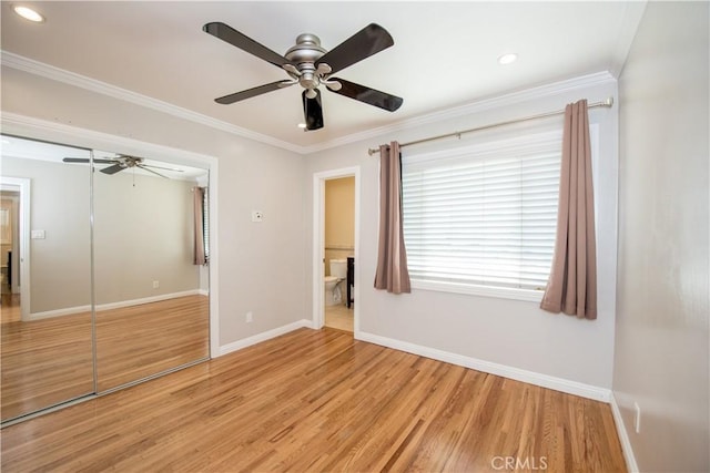 unfurnished bedroom with light hardwood / wood-style floors, a closet, ornamental molding, and ceiling fan