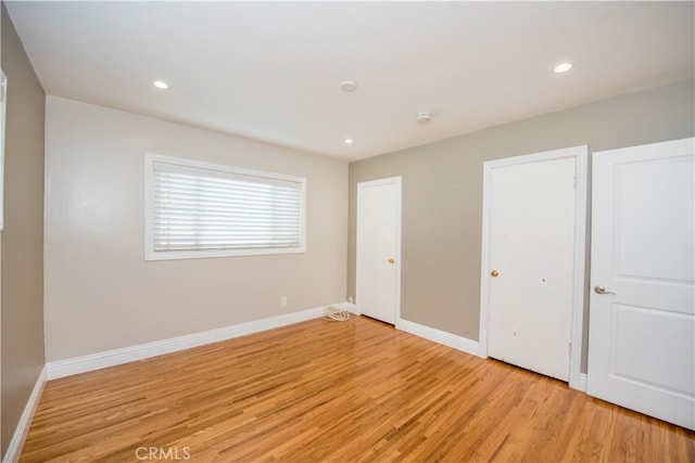 unfurnished bedroom with light wood-type flooring