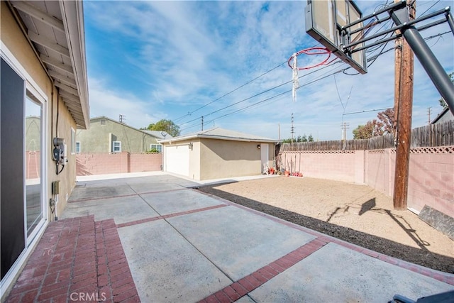 view of patio / terrace with a garage and an outdoor structure