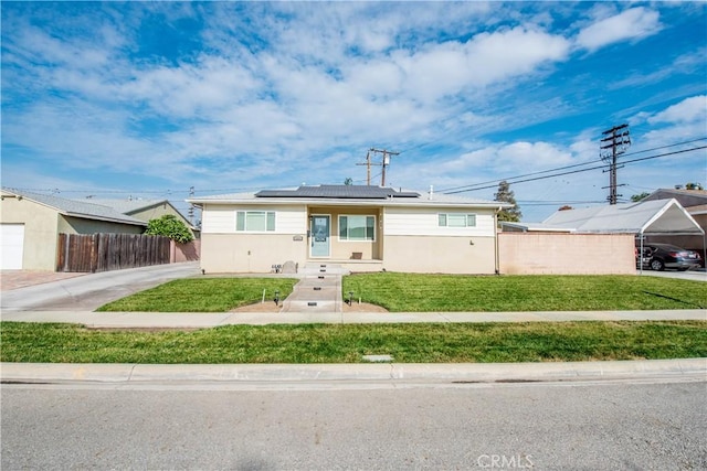 bungalow featuring solar panels and a front lawn