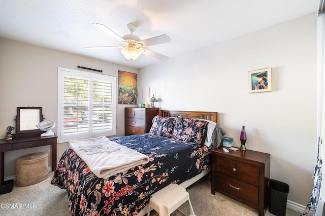 bedroom with ceiling fan and light colored carpet