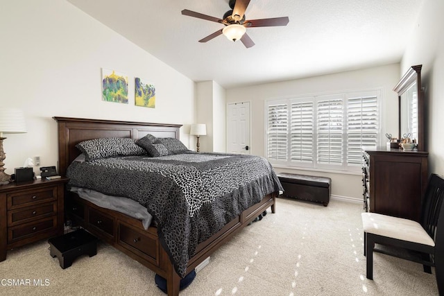 bedroom with lofted ceiling, light colored carpet, and ceiling fan