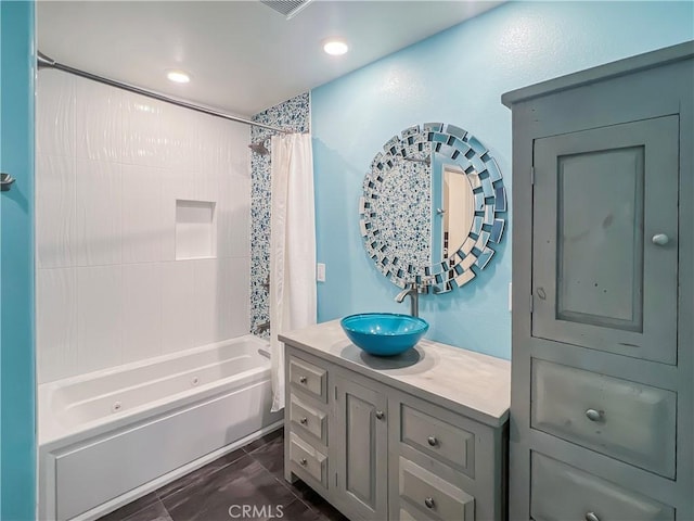 bathroom featuring shower / bath combo and vanity