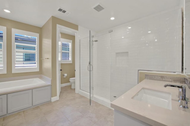 full bathroom featuring toilet, vanity, and shower with separate bathtub