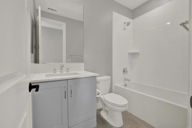 full bathroom featuring tile patterned floors, toilet, vanity, and tiled shower / bath