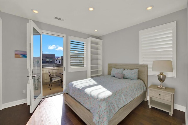 bedroom featuring access to exterior and dark hardwood / wood-style flooring