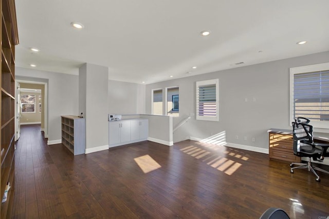 home office with dark hardwood / wood-style flooring