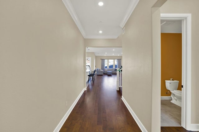 hallway featuring dark wood-type flooring and ornamental molding