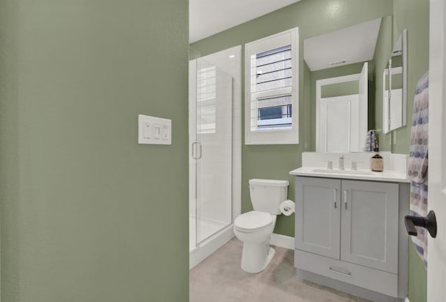 bathroom with a shower with shower door, vanity, tile patterned floors, and toilet