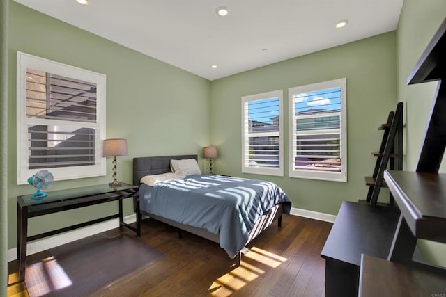 bedroom with dark hardwood / wood-style floors