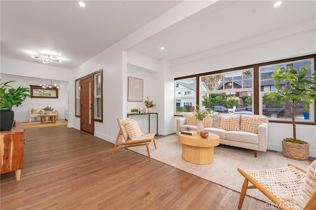 living room featuring a chandelier and hardwood / wood-style flooring